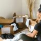 woman sat in front of boxes filled with items to declutter her home